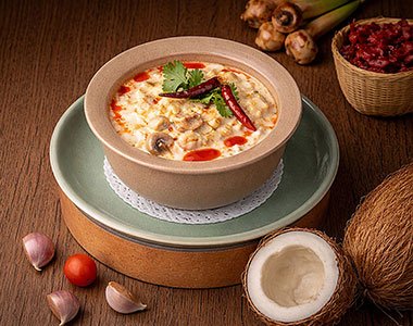 Tom Kha (ต้มข่า ไก่/กุ้ง) - Traditional Thai soup featuring tender chicken or prawns simmered in a creamy coconut broth - Angle 2