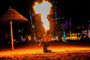 Thai fire dance performer spitting fire on the beach in Koh Samui, Thailand